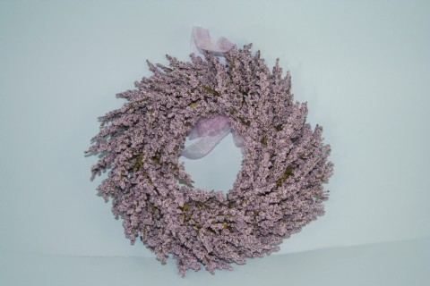 An artificial lavender wreath decorated with chiffon ribbon